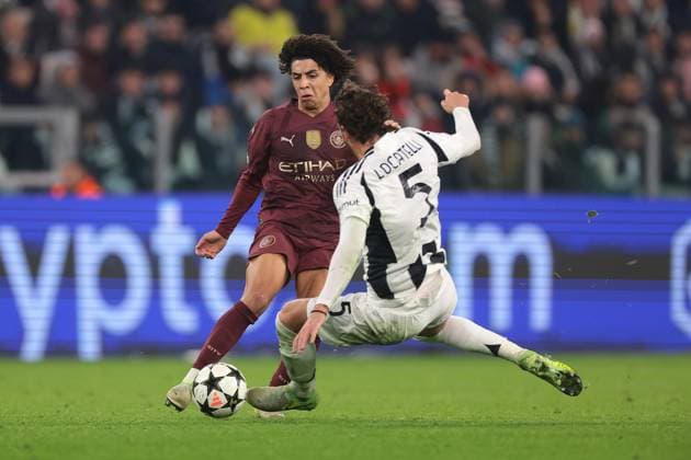 Turin, Italy, 11th December 2024. Manuel Locatelli of Juventus challenges Rico Lewis of Manchester City the UEFA Champions League match at Juventus Stadium, Turin. Picture credit should read: Jonathan Moscrop Sportimage EDITORIAL USE ONLY. No use with unauthorised audio, video, data, fixture lists, club league logos or live services. Online in-match use limited to 120 images, no video emulation. No use in betting, games or single club league player publications. SPI-3517-0005
