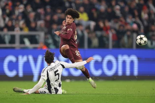 Turin, Italy, 11th December 2024. Manuel Locatelli of Juventus challenges Rico Lewis of Manchester City the UEFA Champions League match at Juventus Stadium, Turin. Picture credit should read: Jonathan Moscrop Sportimage EDITORIAL USE ONLY. No use with unauthorised audio, video, data, fixture lists, club league logos or live services. Online in-match use limited to 120 images, no video emulation. No use in betting, games or single club league player publications. SPI-3517-0007
