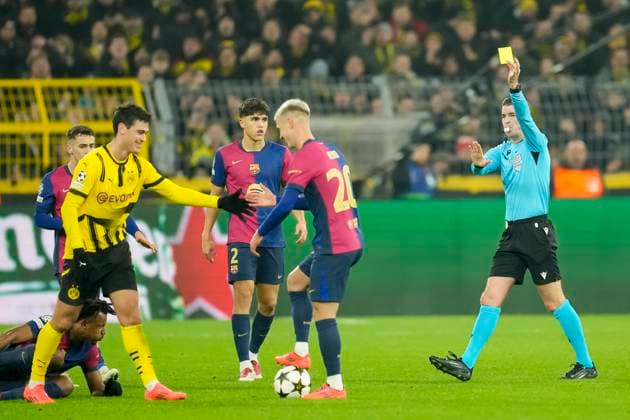 Referee Francois Letexier show the yellow card during the UEFA Champions League 2024 25 League Phase MD6 match between Borussia Dortmund and FC Barcelona at Signal Iduna Park on December 11, 2024 in Dortmund, Germany Photo by Alex Gottschalk DeFodi Images Defodi 001 BVBFCB20241211 198 Defodi-001