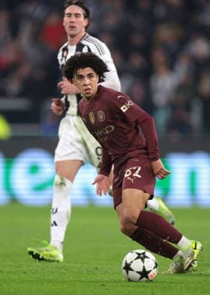 Turin, Italy, 11th December 2024. Dusan Vlahovic of Juventus looks on as Rico Lewis of Manchester City passes the ball during the UEFA Champions League match at Juventus Stadium, Turin. Picture credit should read: Jonathan Moscrop Sportimage EDITORIAL USE ONLY. No use with unauthorised audio, video, data, fixture lists, club league logos or live services. Online in-match use limited to 120 images, no video emulation. No use in betting, games or single club league player publications. SPI-3517-0063