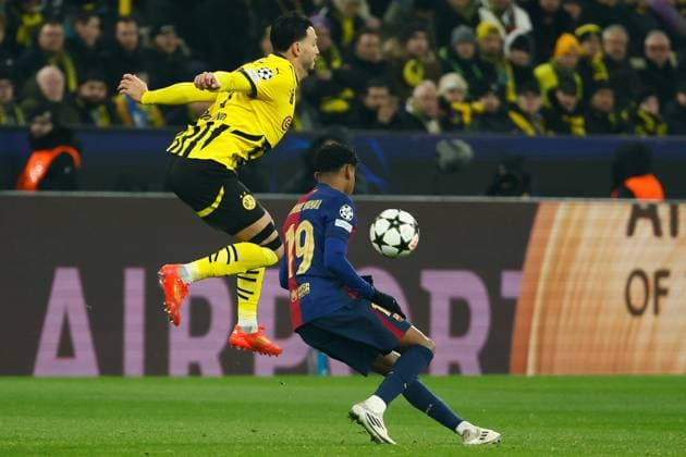 (241212) -- DORTMUND, Dec. 12, 2024 -- Ramy Bensebaini (L) of Borussia Dortmund vies with Lamine Yamal of Barcelona during the UEFA Champions League match between Borussia Dortmund and FC Barcelona, Barca in Dortmund, Germany, Dec. 11, 2024. (Photo by Joachim Bywaletz Xinhua) (SP)GERMANY-DORTMUND-FOOTBALL-UEFA CHAMPIONS LEAGUE-DORTMUND VS BARCELONA ZhangxFan 
