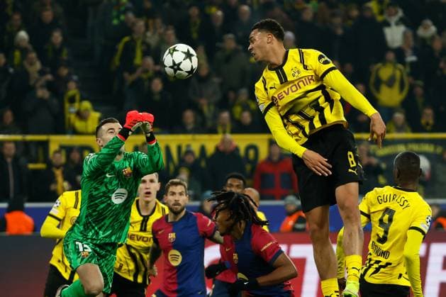 (241212) -- DORTMUND, Dec. 12, 2024 -- Inaki Pena (L), goal keeper of Barcelona, challenges Felix Nmecha (top, R) of Borussia Dortmund during the UEFA Champions League match between Borussia Dortmund and FC Barcelona, Barca in Dortmund, Germany, Dec. 11, 2024. (Photo by Joachim Bywaletz Xinhua) (SP)GERMANY-DORTMUND-FOOTBALL-UEFA CHAMPIONS LEAGUE-DORTMUND VS BARCELONA ZhangxFan 