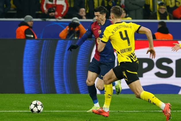 (241212) -- DORTMUND, Dec. 12, 2024 -- Nico Schlotterbeck (R) of Borussia Dortmund vies with Robert Lewandowski of Barcelona during the UEFA Champions League match between Borussia Dortmund and FC Barcelona, Barca in Dortmund, Germany, Dec. 11, 2024. (Photo by Joachim Bywaletz Xinhua) (SP)GERMANY-DORTMUND-FOOTBALL-UEFA CHAMPIONS LEAGUE-DORTMUND VS BARCELONA ZhangxFan 