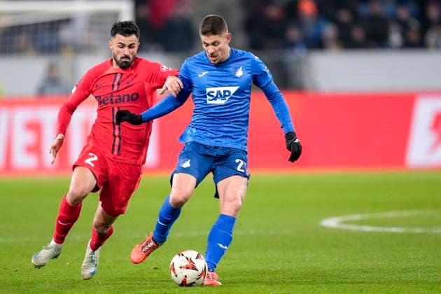 v.li.: Valentin Cretu (FCSB Bukarest, 2), Andrej Kramaric (Hoffenheim, 27), Zweikampf, Spielszene, Duell, duel, tackle, tackling, Dynamik, Action, Aktion, 12.12.2024, Sinsheim (Deutschland), Fussball, UEFA Europa League, Gruppenphase, TSG 1899 Hoffenheim - FCSB Bukarest, REGULATIONS PROHIBIT ANY USE OF PHOTOGRAPHS AS IMAGE SEQUENCES AND OR QUASI-VIDEO. xozx