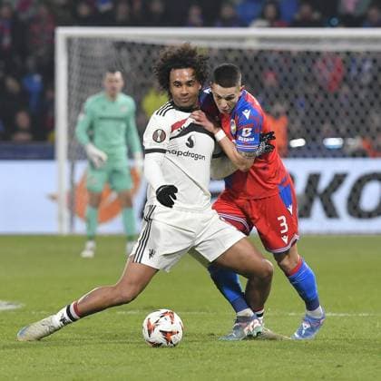 Joshua Zirkzee of Manchester, left, and Svetozar Markovic of Plzen in action during the football Europa League 6th round match Viktoria Plzen vs Manchester United, ManU in Pilsen, Czech Republic, December 12, 2024. (CTKxPhoto MiroslavxChaloupka) CTKPhotoP2024121207067  CTKPhotoP2024121207067
