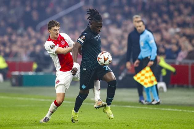 AMSTERDAM, 12-12-2024 , JohanCruyff Arena, Europa League Football, Ajax - Lazio Roma. Lazio Roma player Loum Tchaouna and Ajax player Youri Baas Ajax - Lazio Roma  x27001896x Copyright: