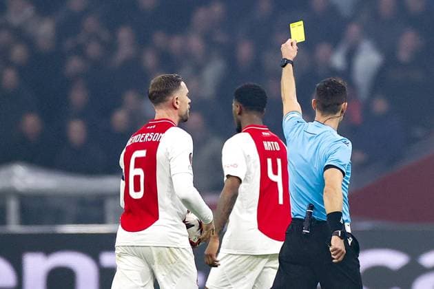 AMSTERDAM, 12-12-2024 , JohanCruyff Arena, Europa League Football, Ajax - Lazio Roma. referee Ivan Kruzliak give Ajax player Jorrel Hato a yellow card Ajax - Lazio Roma  x27001897x Copyright: