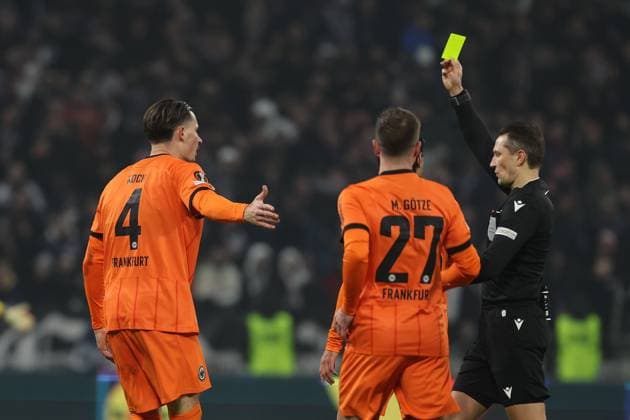 2024 12 12 6 Matchday UEFA Europa League Olympique Lyonnais Eintracht Frankfurt v l , Robin Koch Eintracht Frankfurt receives yellow card from referee, referee Andris Treimanis LVA DFL REGULATIONS PROHIBIT ANY USE OF PHOTOGRAPHS AS IMAGE SEQUENCES AND OR QUASI VIDEO Copyright: JoaquimxFerreira