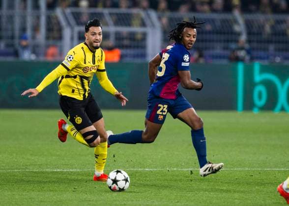 Signal Iduna Park, Dortmund, 11 12 2024 Emre Can of Dortmund challenges Jules KoundÃ of Barcelona during the Championsleague match Borussia Dortmund vs FC Barcelona