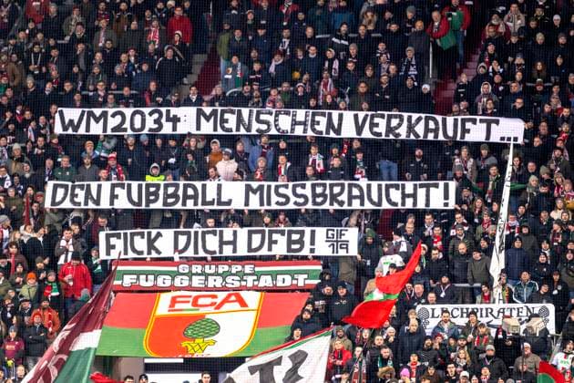 14 12 2024, Football 1 Bundesliga 2024 2025, Matchday 14, FC Augsburg Bayer Leverkusen, in the WWK Arena Augsburg, Augsburg fans protest against the World Cup being awarded to Saudi Arabia 2034 World Cup 2034 people sold¦ football abused, Fuck you DFB