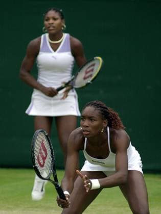 sisters Serena Williams and Venus Williams July 2000 playing doubles at Wimbledon the day before they meet in the Singles semi finals Wimbledon Tennis Championship 2000 DMGTCHPDPICT000349381544