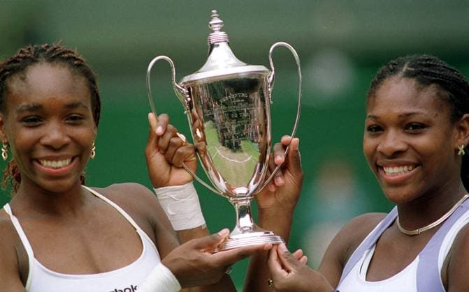 Venus Williams and sister Serena Williams holding the trophy, July 2000 after winning the Womens Doubles Final against Julie Halard-Decugis & Ai Sugiyama, at Wimbledon Wimbledon Tennis Championships 2000 Womens Doubles Final DMGTCHPDPICT000404159303