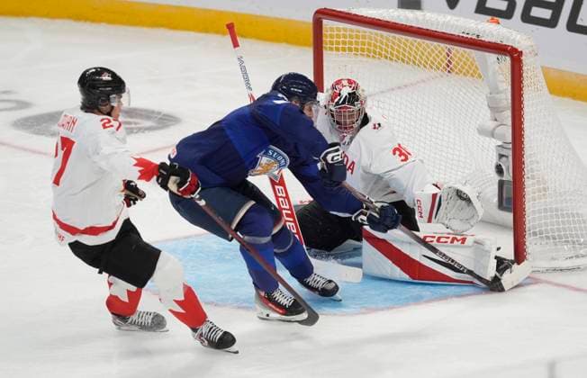 December 26, 2024, Ottawa, On, Canada: Canada forward Easton Cowan, left, defends as goalkeeper Carter George (30) blocks the puck with his foot as Finland forward Heikki Ruohonen tries to score during second period IIHF World Junior Hockey Championship tournament action, Thursday, Dec.26, 2024 in Ottawa. Carter George Easton Cowan Heikki Ruohonen  - ZUMAc35_ 20241226_zaf_c35_093 Copyright: xAdrianxWyldx