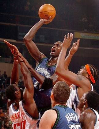 KRT SPORTS STORY SLUGGED: TIMBERWOLVES-BOBCATS KRT PHOTOGRAPH BY PATRICK SCHNEIDER CHARLOTTE OBSERVER (January 5) CHARLOTTE, NC -- Minnesota s Kevin Garnett goes over Charlotte s Emeka Okafor, left, and teammate Melvin Ely during the first half of their game on Wednesday night, January 5, 2005 at the Charlotte Coliseum. (mvw) 2005 CHARLOTTE NC USA EDITORIAL USE ONLY Copyright: xx 1013565 PATRICKxSCHNEIDERx krtphotoslive157686