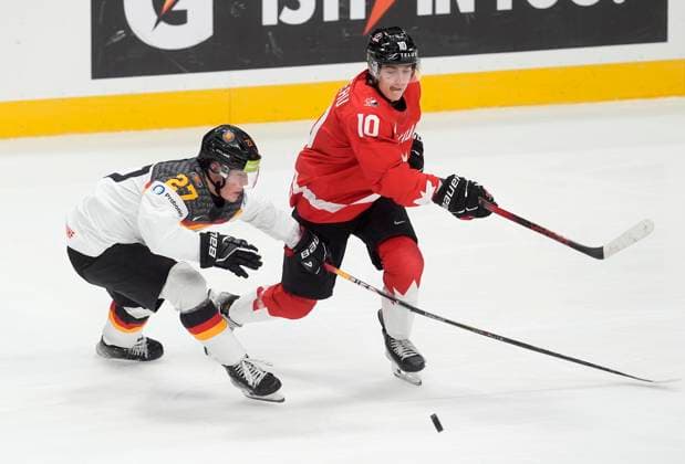 December 29, 2024, Ottawa, On, Canada: Canada forward Bradly Nadeau breaks the stick of Germany forward Simon Seidel as they chase a bouncing puck during second period IIHF World Junior Hockey Championship tournament action in Ottawa, Sunday, Dec. 29, 2024. Bradly Nadeau Simon Seidel  - ZUMAc35_ 20241229_zaf_c35_089 Copyright: xAdrianxWyldx