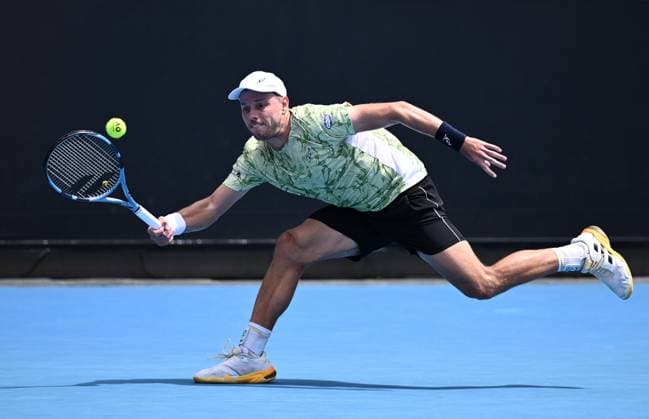 TENNIS AUSTRALIAN OPEN, James Duckworth of Australia returns during his round 1 match against Dominic Stricker of Switzerland during the 2025 Australian Open at Melbourne Park in Melbourne, Monday, January 13, 2025. ( NO ARCHIVING, EDITORIAL USE ONLY, NO USE IN BOOKS WITHOUT CONSENT MELBOURNE VICTORIA AUSTRALIA  Copyright: xJOELxCARRETTx 20250113116244049223