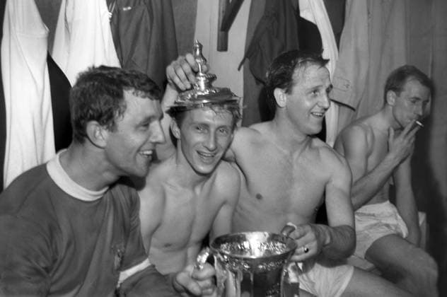 Football - 1963 FA Cup Final - Manchester United, ManU 3 Leicester City 1 Bobby Charlton, far right, (smoking Cigarette) as David Herd, Denis Law and Maurice Setters celebrate with the trophy in the Wembley changing rooms. 