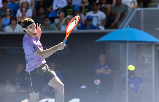 (250118) -- MELBOURNE, Jan. 18, 2025 -- Taylor Fritz hits a return during the men s singles 3rd round match between Taylor Fritz of the United States and Gael Monfils of France at Australian Open tennis tournament in Melbourne, Australia, Jan. 18, 2025. (Photo by Xinhua) (SP)AUSTRALIA-MELBOURNE-TENNIS-AUSTRALIAN OPEN-DAY 7 HuxJingchen 