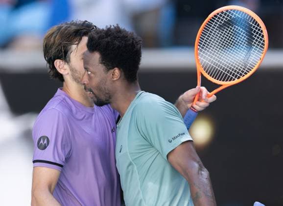 (250118) -- MELBOURNE, Jan. 18, 2025 -- Gael Monfils (R) hugs Taylor Fritz after the men s singles 3rd round match between Taylor Fritz of the United States and Gael Monfils of France at Australian Open tennis tournament in Melbourne, Australia, Jan. 18, 2025. (Photo by Xinhua) (SP)AUSTRALIA-MELBOURNE-TENNIS-AUSTRALIAN OPEN-DAY 7 HuxJingchen 