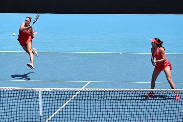 Marta Kostyuk blonde hair , UKR, and Elena Gabriela Ruse red cap , ROU, during womenÂs doubles at 2025 Australian Open in Melbourne, 19 01 2025