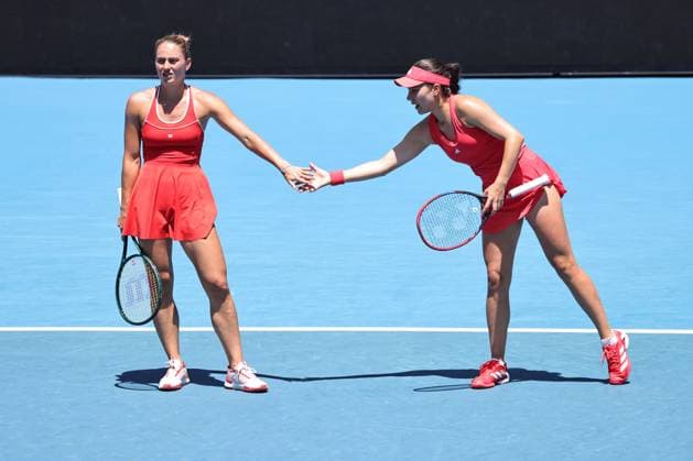 Marta Kostyuk blonde hair , UKR, and Elena Gabriela Ruse red cap , ROU, during womenÂs doubles at 2025 Australian Open in Melbourne, 19 01 2025