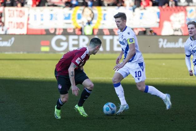 in duel, action, with Marvin Wanitzek 10 Karlsruher SC , 1 FC Nuernberg vs Karlsruher SC, Soccer, 2 Bundesliga, 18 Matchday, 19 01 2025 DFB regulations prohibit any use of photographs as image sequences and or quasi video Nuernberg Bayern Germany Copyright: xkolbert-press MartinxAgüerax