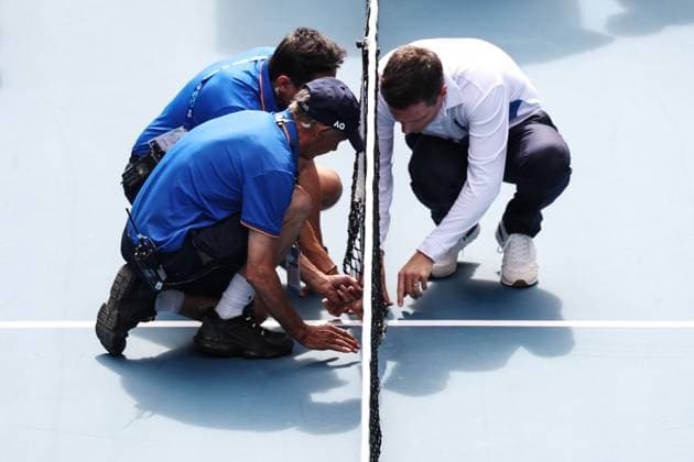 Officials attend to the broken net during the fourth round match between Rune and Sinner Australian Open, Day Nine, Tennis, Melbourne Park, Melbourne, Australia - 20 Jan 2025  Copyright: xEllaxLing Shutterstockx 15105040ay