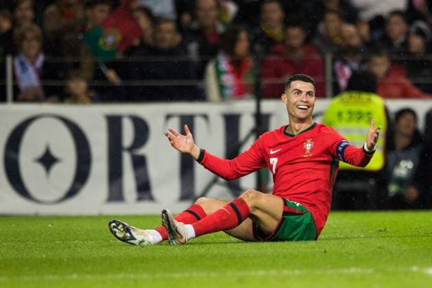 Soccer match, captain Cristiano RONALDO CR7 Portugal sits on the ground grass, has just been brought down, complains with an ironic smile and astonished eyes with both arms raised towards the referee not to be seen, demands a free kick, Estadio do Dragao, Porto, Portugal Copyright: xGaetanoxDixRosax