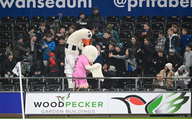 21st January 2025; Swansea.com Stadium, Swansea, Wales; EFL Championship Football, Swansea City versus Sheffield United; Cyril and Cybil the swan say hello to young fans during warm-up  ActionPlus12741468 AledxHopkins