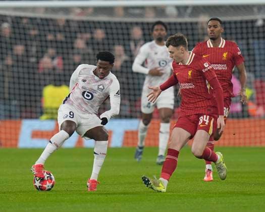 21st January 2025; Anfield, Liverpool, Merseyside, England; Champions League Football, Liverpool versus Lille; Jonathan David of Lille controls the ball under pressure from Conor Bradley of Liverpool  ActionPlus12741662 StevenxFlynn