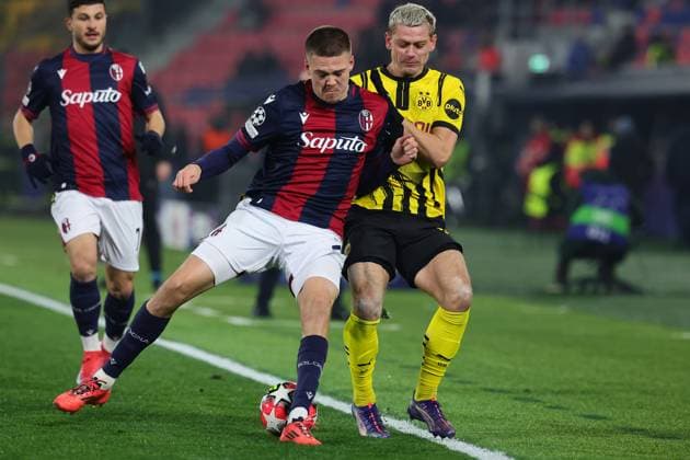 Emil Holm of Bologna FC and Julian Ryerson of Borussia Dortmund compete for the ball during the Champions League football match between Bologna FC and Borussia Dortmund at Renato Dall Ara stadium in Bologna (Italy), January 21st, 2025. cesarexpurini