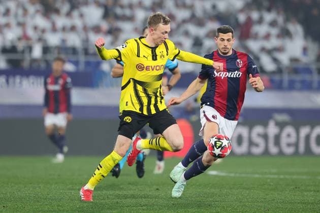 Maximilian Beier of Borussia Dortmund and Sam Beukema of Bologna FC compete for the ball during the Champions League football match between Bologna FC and Borussia Dortmund at Renato Dall Ara stadium in Bologna (Italy), January 21st, 2025. cesarexpurini