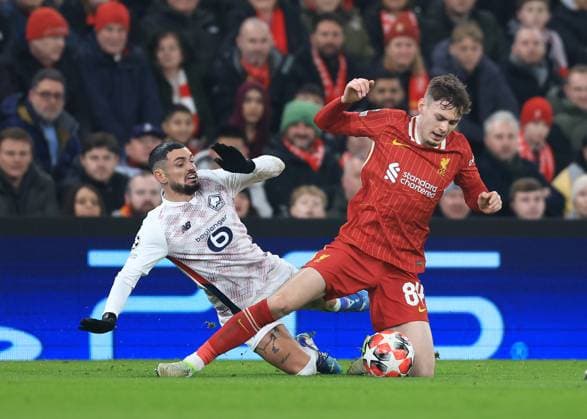 Liverpool, England, 21st January 2025. Liverpool s Conor Bradley with Lille™s Remy Cabella during the UEFA Champions League match at Anfield, Liverpool. Picture credit should read: Jessica Hornby Sportimage EDITORIAL USE ONLY. No use with unauthorised audio, video, data, fixture lists, club league logos or live services. Online in-match use limited to 120 images, no video emulation. No use in betting, games or single club league player publications. SPI_037_JH_Liverpool_Lille SPI-3613-0029