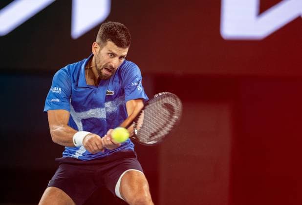 (250122) -- MELBOURNE, Jan. 22, 2025 -- Novak Djokovic hits a return during the men s singles quarterfinal between Novak Djokovic of Serbia and Carlos Alcaraz of Spain at Australian Open tennis tournament in Melbourne, Australia, Jan. 21, 2025. (Photo by Xinhua) (SP)AUSTRALIA-MELBOURNE-TENNIS-AUSTRALIAN OPEN-DAY 10 HuxJingchen 