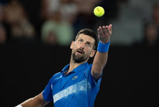 (250122) -- MELBOURNE, Jan. 22, 2025 -- Novak Djokovic serves during the men s singles quarterfinal between Novak Djokovic of Serbia and Carlos Alcaraz of Spain at Australian Open tennis tournament in Melbourne, Australia, Jan. 21, 2025. (Photo by Xinhua) (SP)AUSTRALIA-MELBOURNE-TENNIS-AUSTRALIAN OPEN-DAY 10 HuxJingchen 