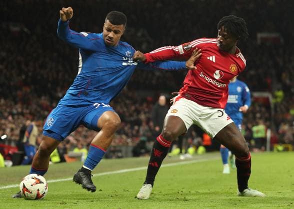 Hamza Igamane of Rangers battles for the ball with Kobbie Mainoo of Manchester United, ManU during the Europa League group phase match at Old Trafford, Manchester. Manchester United v Rangers, UEFA Europa League, Group Stage, Football, Old Trafford, Manchester, UK - 23 Jan 2025 EDITORIAL USE ONLY No use with unauthorised audio, video, data, fixture lists, club league logos or live services. Online in-match use limited to 120 images, no video emulation. No use in betting, games or single club league player publications. Copyright: xRangersxFC Shutterstockx 15111693iv