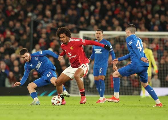 Nicolas Raskin of Rangers battles for the ball with Joshua Zirkee of Manchester United, ManU during the Europa League group phase match at Old Trafford, Manchester. Manchester United v Rangers, UEFA Europa League, Group Stage, Football, Old Trafford, Manchester, UK - 23 Jan 2025 EDITORIAL USE ONLY No use with unauthorised audio, video, data, fixture lists, club league logos or live services. Online in-match use limited to 120 images, no video emulation. No use in betting, games or single club league player publications. Copyright: xRangersxFC Shutterstockx 15111693ke