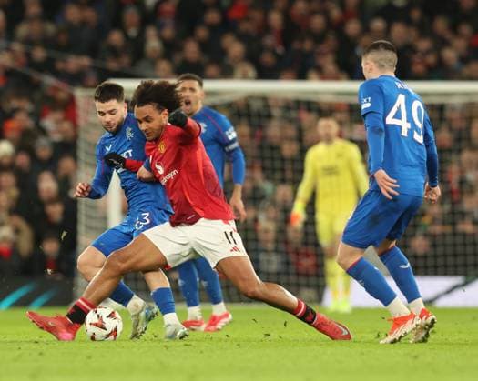 Nicolas Raskin of Rangers battles for the ball with Joshua Zirkee of Manchester United, ManU during the Europa League group phase match at Old Trafford, Manchester. Manchester United v Rangers, UEFA Europa League, Group Stage, Football, Old Trafford, Manchester, UK - 23 Jan 2025 EDITORIAL USE ONLY No use with unauthorised audio, video, data, fixture lists, club league logos or live services. Online in-match use limited to 120 images, no video emulation. No use in betting, games or single club league player publications. Copyright: xRangersxFC Shutterstockx 15111693kd