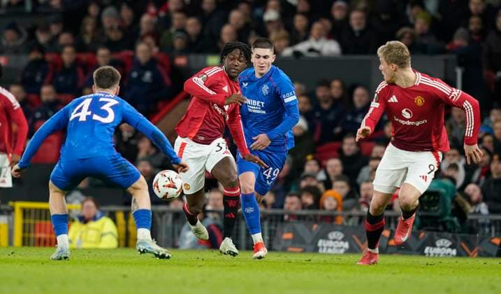 Manchester, England, 23rd January 2025. Kobbie Mainoo of Manchester United, ManU (C) is challenged by Bailey Rice of Rangers during the UEFA Europa League match at Old Trafford, Manchester. Picture credit should read: Andrew Yates Sportimage EDITORIAL USE ONLY. No use with unauthorised audio, video, data, fixture lists, club league logos or live services. Online in-match use limited to 120 images, no video emulation. No use in betting, games or single club league player publications. SPI_033_AY_MAN_UTD_RANGERS SPI-3616-0033