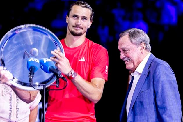MELBOURNE, VIC - JANUARY 26: Alexander Zverev of Germany recieves his finalist trophy from John Newcome after the Men s Singles Final of the 2025 Australian Open on January 26 2025, at Melbourne Park in Melbourne, Australia. (Photo by Jason Heidrich Icon Sportswire) TENNIS: JAN 26 Australian Open EDITORIAL USE ONLY Icon250126016