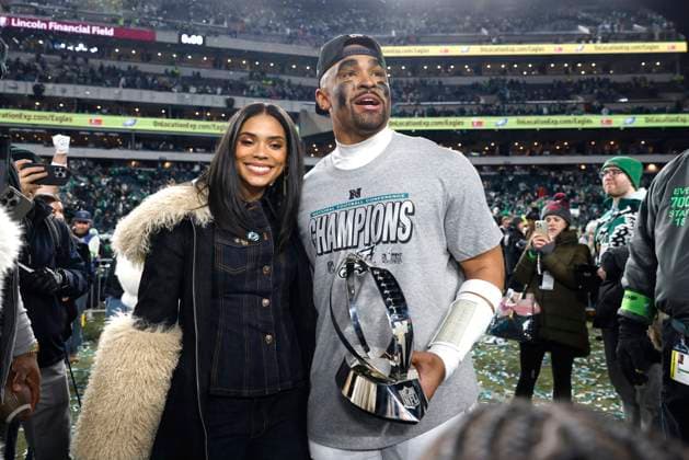 Philadelphia Eagles quarterback Jalen Hurts holds the NFC championship trophy with his fiancÃ Bry Burrows after the Eagles defeated the Washington Commanders at Lincoln Financial Field in Philadelphia on Sunday, January 26, 2025.  PHI20250126012 LAURENCExKESTERSON
