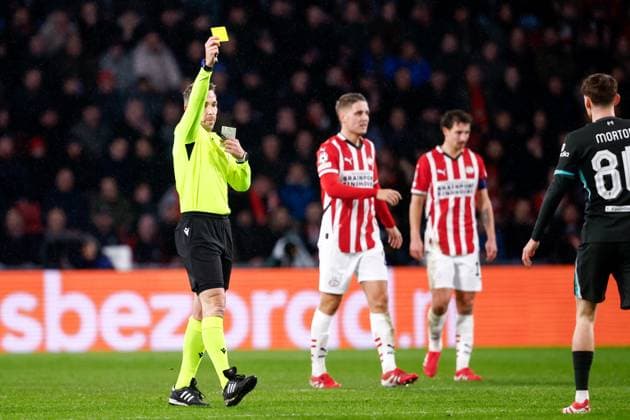 2025-01-29 PSV Eindhoven v Liverpool FC - UEFA Champions League 2024 25 League Phase MD8 EINDHOVEN, NETHERLANDS - JANUARY 29: Referee Tobias Stieler shows a yellow card to Tyler Morton of Liverpool FC during the UEFA Champions League 2024 25 League Phase MD8 match between PSV Eindhoven and Liverpool FC at PSV Stadion on January 29, 2025 in Eindhoven, Netherlands. Eindhoven PSV Stadion Netherlands Content not available for redistribution in The Netherlands directly or indirectly through any third parties. Copyright: xBroerxvanxdenxBoomx