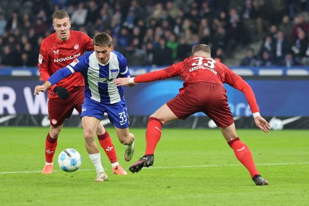 2 Soccer Bundesliga Hertha BSC 1 FC Kaiserslautern Micha Karbownik Hertha BSC Berlin 33 taking a shot on goal against Jan Elvedi Kaiserslautern 33 , left Filip Kalo Kaiserslautern 26 during the match in the 2 Soccer Bundesliga Hertha BSC 1 FC Kaiserslautern in Berlin, Olympiastadion, on 08 02 2025 DFB regulations prohibit any use of photographs as image sequences and or quasi video Copyright: xBEAUTIFULxSPORTS Frankex
