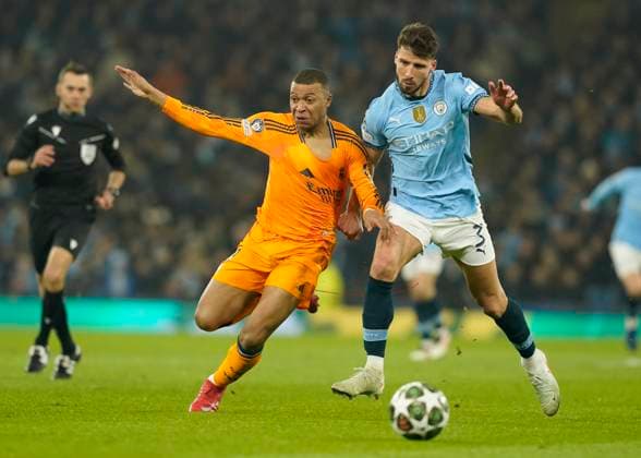 Manchester, England, 11th February 2025. Manchester City s Ruben Dias with Real Madrid s Kylian Mbappe during the UEFA Champions League match at the Etihad Stadium, Manchester. Picture credit should read: Andrew Yates Sportimage EDITORIAL USE ONLY. No use with unauthorised audio, video, data, fixture lists, club league logos or live services. Online in-match use limited to 120 images, no video emulation. No use in betting, games or single club league player publications. SPI_AY_021_Man_City_Real_Madrid SPI-3675-0056