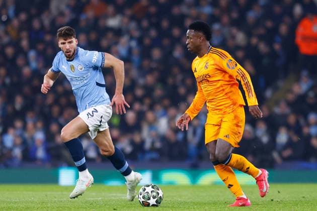 February 11, 2025, Manchester, Manchester, ENGLAND: Vinicius Junior of Real Madrid and Ruben Dias of Manchester City in action during the UEFA Champions League 2024 25 League Knockout Play-off First Leg match between Manchester City and Real Madrid at Manchester City Stadium on February 11, 2025, in Manchester, England. Manchester ENGLAND - ZUMAa181 20250211_zaa_a181_138 Copyright: xDennisxAgyemanx