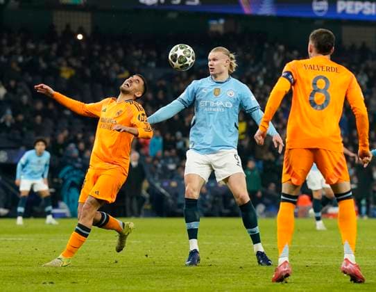 Manchester, England, 11th February 2025. Manchester City™s Erling Haaland with Real Madrid s Dani Ceballos during the UEFA Champions League match at the Etihad Stadium, Manchester. Picture credit should read: Andrew Yates Sportimage EDITORIAL USE ONLY. No use with unauthorised audio, video, data, fixture lists, club league logos or live services. Online in-match use limited to 120 images, no video emulation. No use in betting, games or single club league player publications. SPI_AY_049_Man_City_Real_Madrid SPI-3675-0110