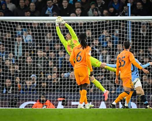 11th February 2025; Etihad Stadium, Manchester, England; UEFA Champions League Play Off Round 1 Football, Manchester City versus Real Madrid; Thibaut Courtois of Real Madrid makes a diving save from Phil Foden of Manchester City  ActionPlus12749776 GodfreyxPitt