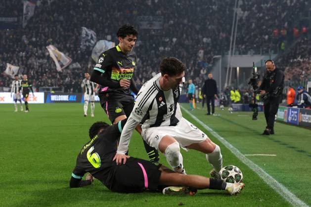 Turin, Italy, 11th February 2025. Dusan Vlahovic of Juventus is challenged by Ryan Flamingo and Richard Ledezma of PSV Eindhoven during the UEFA Champions League match at Allianz Stadium, Turin. Picture credit should read: Jonathan Moscrop Sportimage EDITORIAL USE ONLY. No use with unauthorised audio, video, data, fixture lists, club league logos or live services. Online in-match use limited to 120 images, no video emulation. No use in betting, games or single club league player publications. SPI_123_JM_JUVE_PSV_UCL SPI-3661-0117