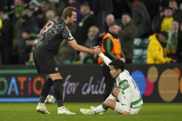 Harry Kane of Bayern Munich picked up dejected Reo Hatate of Celtic after final whistle Celtic v Bayern Munich, UEFA Champions League, Knockout Round Play-offs, First Leg, Football, Celtic Park, Glasgow, UK - 12 Feb 2025 EDITORIAL USE ONLY No use with unauthorised audio, video, data, fixture lists, club league logos or live services. Online in-match use limited to 120 images, no video emulation. No use in betting, games or single club league player publications.  Copyright: xStuartxWallace Shutterstockx 15136907ej