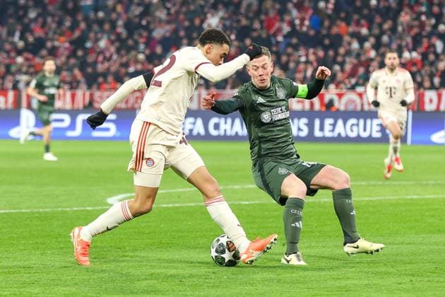 in duel, action, with Jamal Musiala 42 FC Bayern Muenchen , Callum McGregor 42 Celtic Glasgow , FC Bayern Muenchen vs Celtic Glasgow, Football, Champions League, Play offs, second leg, 18 02 2025 Muenchen Bayern Germany Copyright: xkolbert-press ChristianxKolbertx